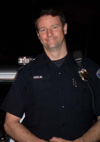 Author Mark Kirlin, in front of a squad car, taken during the summer of 2011.