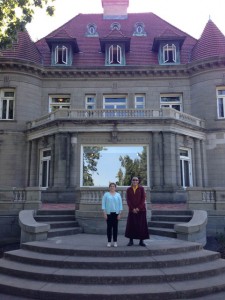 Chamtrul Rinpoche and Jacqueline Mandell in front of Pittock Mansion, a Portland museum