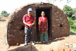 Chij Shrestha with a woman who will live in the new house built for her after the earthquake