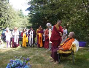 Sangha members present traditional khata offering scarves to His Holiness the Fourth Dodrupchen Rinpoche during his 2014 visit to Whidbey Island