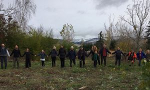 Ashland Zen Center sangha members stand together where they will break ground on their new building project.