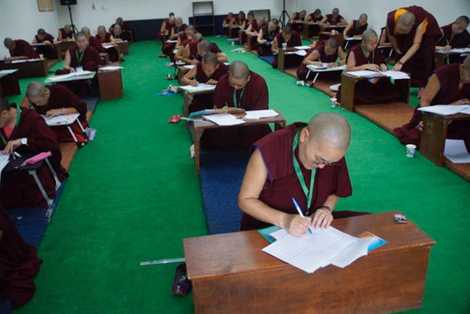 Rows of Tibetan Buddhist nuns taking the geshema exams in 2025, at Dolma Ling Nunnery and Institute.