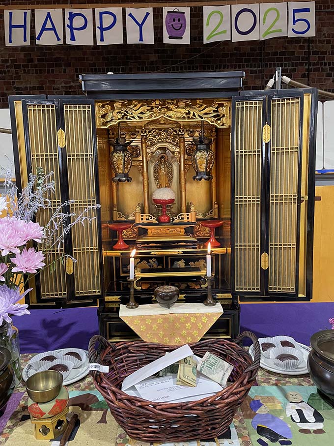 A home altar with Amida statue, in center, was set in the gym for the Spring Equinox Sunday service.