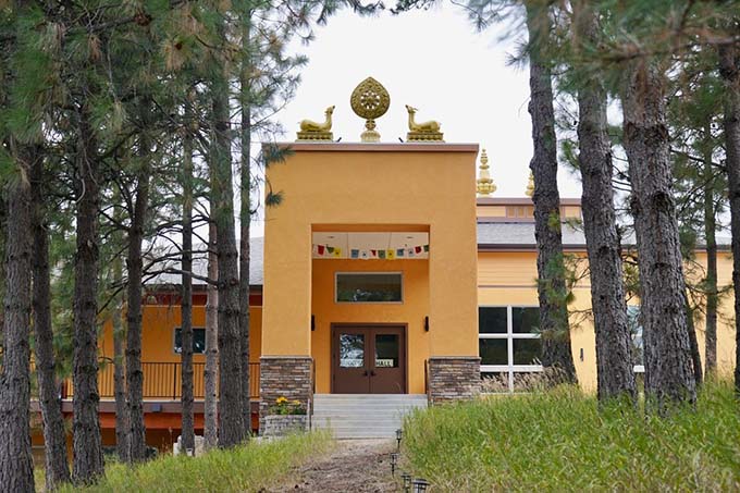 The main entrance to the Buddha Hall, with the deer and Dharma wheel above the door.