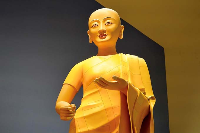 Venerable Mahaprajapati, the first nun, stands to the Buddha’s left on the main altar.