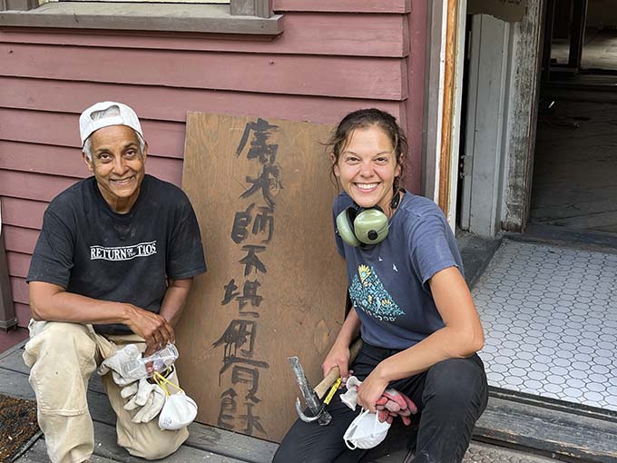 Heather Hynes and Kishán take a break from demolition at the Mason Farm.