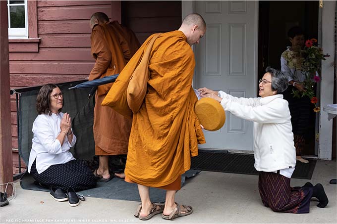Alms offering at the Pacific Hermitage annual “robes offering ceremony,” called a Pah Bah.