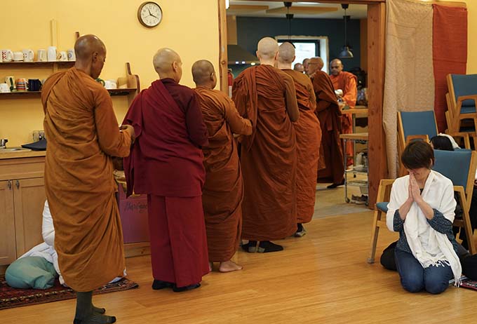 The monastics line up for the meal offered by lay attendees before the ceremony takes place.
