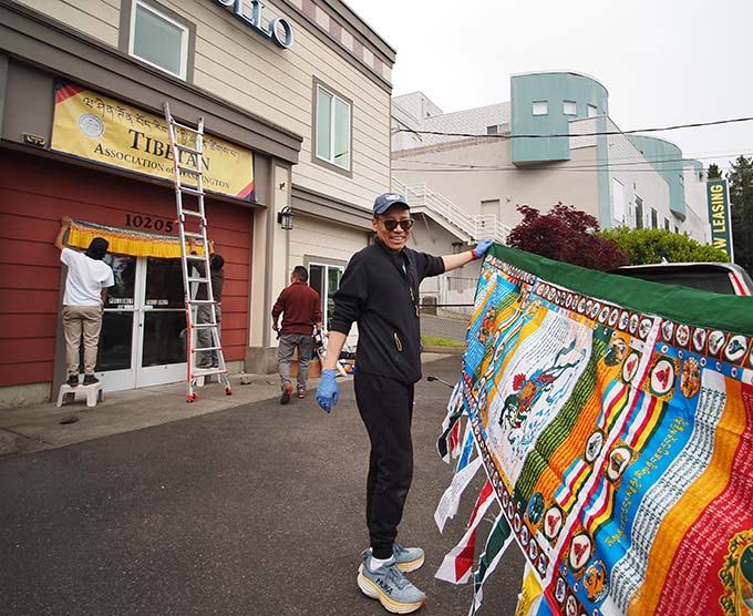 In May, Tibetan Association of Washington Board Member Lobsang Tsering helping put up a prayer flag with other volunteers at the Tibetan Community Center.