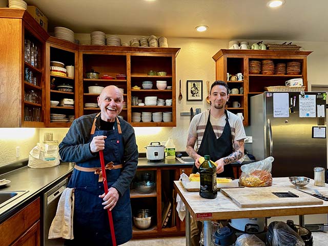 Waymire and a resident, preparing food in the kitchen of the residence hall