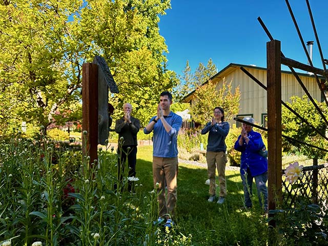Bowing at the garden altar, next to the barn that will be remodeled into the new zendo