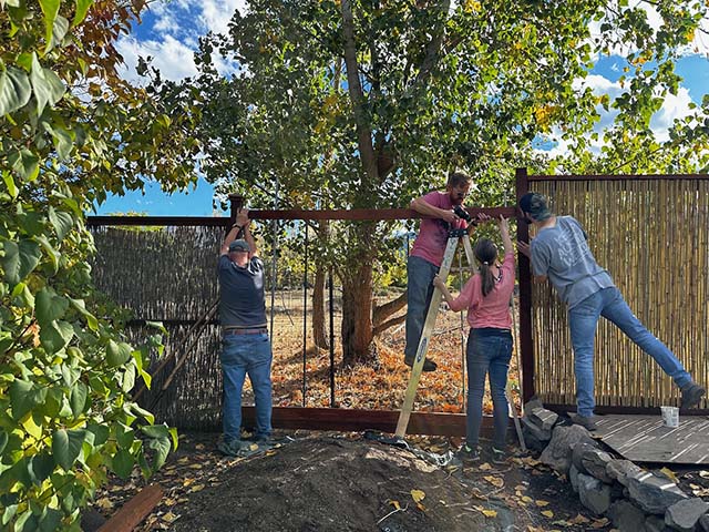 Sangha rebuilding a fence