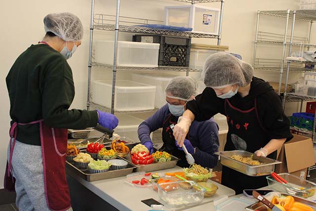 Volunteers gladly prepared food as an offering to the Buddha