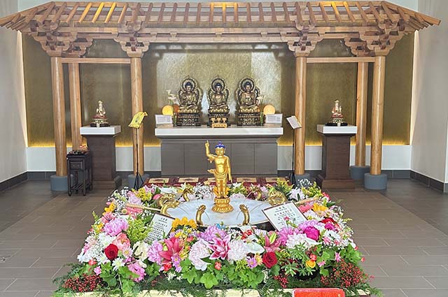Adorned with flowers, the Buddha Bathing pavilion featured Prince Siddhartha standing beneath the water of the Nine Dragons
