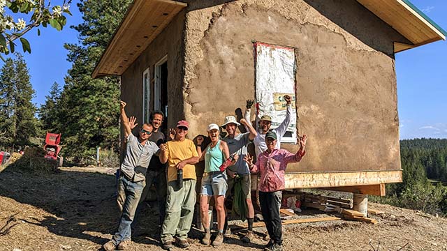 Celebrations following early stages of mudding Orion cabin with clay and soil sourced at Clear Sky. From left: Thomas Fox, Jasmine Nathaniel, Qapel Achariya Doug Duncan, Catherine Pawasarat Sensei, Dean Nicholson, Jordan Allain and Maureen Smith