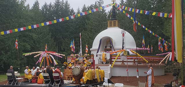 Rev. Kuniaki Onishi, who traveled from the Buddha's birthplace in Lumbini for the peace pagoda blessing, prepares incense sticks at the altar just before the attendees started circumambulating the pagoda to the sound of peace drums
