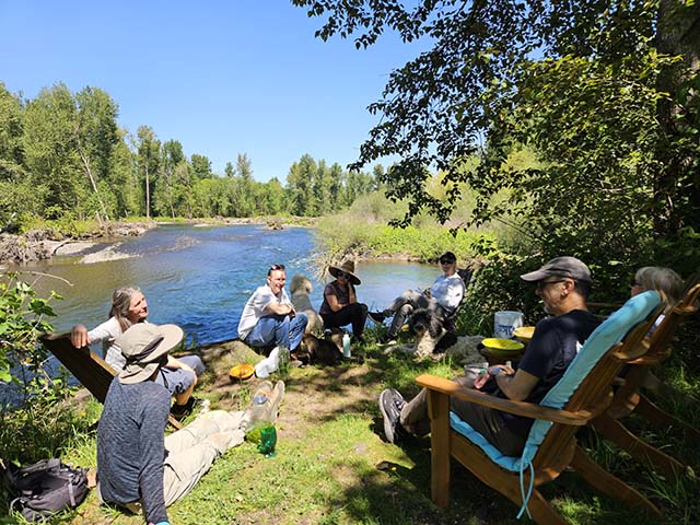 After a morning of service at the Lotus Herd Horse Ranch in Canby, Oregon, sangha members gather for lunch alongside the Molalla River