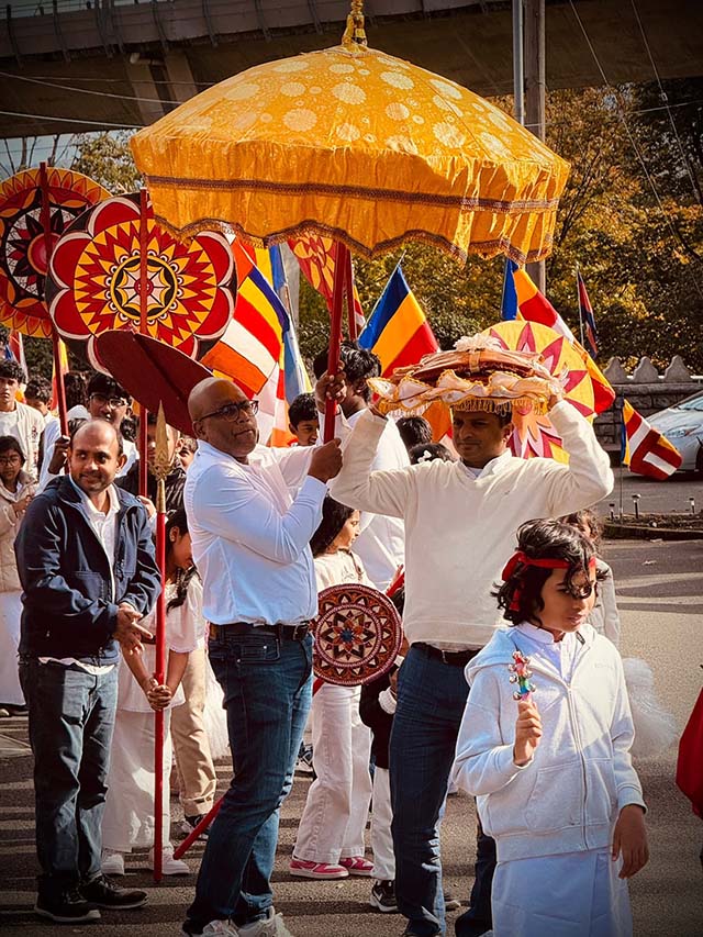 A traditional kathina ceremony procession, where new robes and essential are offered at the conclusion of the monastic rains retreat, features ceremonial parasols