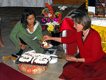 Khadro's tour was timed to commemorate the 25th Anniversary of Chagdud Rinpoche's first visit to the Yukon. Here she cuts a cake with Marie-France looking on.