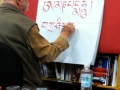 Demonstrating the Tibetan alphabet, during a 2012 booksigning for “Tibetan Calligraphy,” at Portland’s Powell’s books