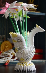 Inmates created exquisite sculptures like this bird with flowers - all made from folded pieces of paper