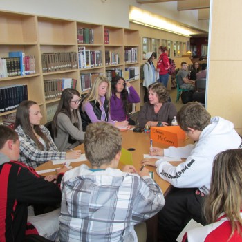 Eileen McCann talks about the dhrama to a group of students at the Snohomish High School Library.