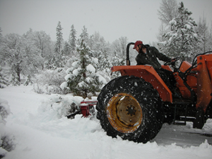 Operations Manager Galen Doucette plowing the road during winter
