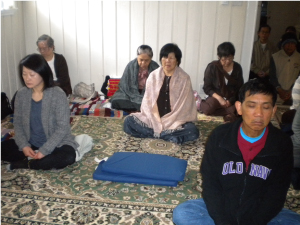 People mediating in the shrine room