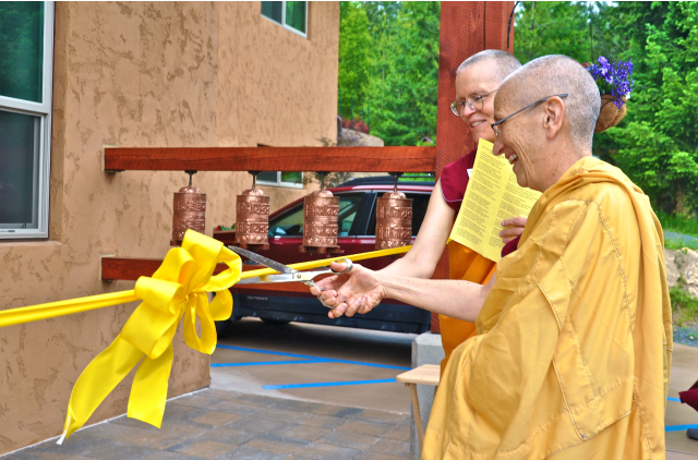 Abbess Ven. Thubten Chodron and Construction Manager Ven. Thubten Tarpa cut the ribbon together