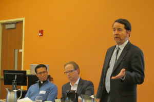 Michael Trice (center), and Jesuit priest Dr. Kang In-gun (left) listen, while Mark Markuly, dean of Seattle University School of Theology and Ministry, welcomes an initial groups of Buddhist leaders to Seattle University in May