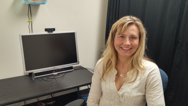 Associate Professor Jessica Sommerville, who received her doctorate at the University of Chicago, next to a computer that tracks children’s eye movements during tests.