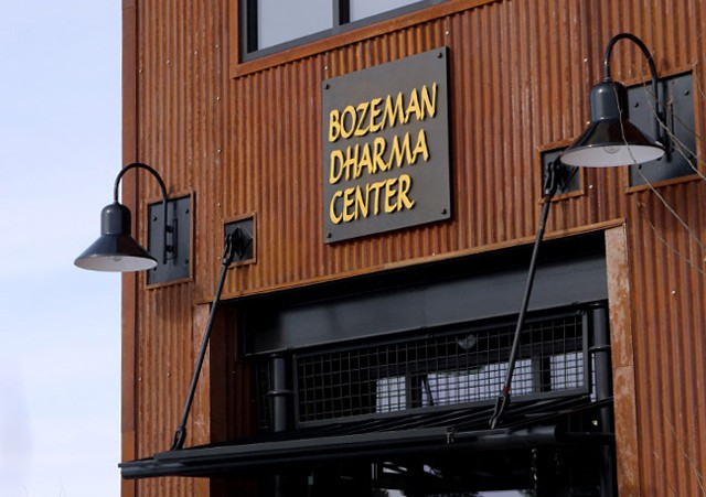 The center sign, on the building’s rusted metal exterior, reflects the aesthetics of the West