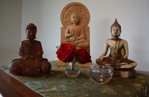 Buddhas from the three resident sanghas, united on a side altar symbolizing the "coming together"