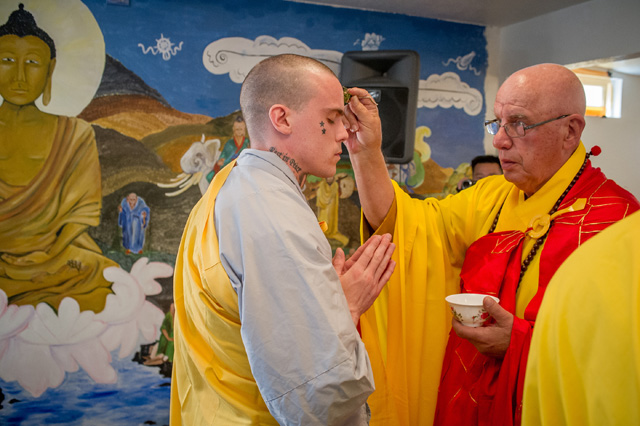 Chris Richards receiving water blessing from Abbot Thich An Giao