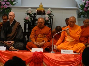 Abbot Phraku Manikanto Bhikkhu delivers opening statements. On his left are Kanjin Cederman Shonin, a priest at the Choeizan Enkyoji Nichiren Buddhist Temple in Seattle, and Phraku Sithdidhamvidesa Bhikkhu