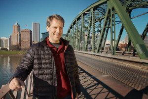 Author Paul Louis Metzger, standing on a bridge in Portland
