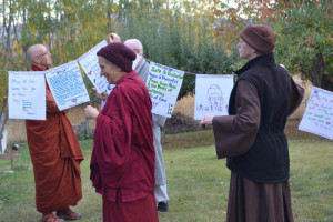 Venerable Thubten Chodron (left), abbot of of Sravasti Abbey, helps hang prayers flags to bless Sravasti Abbey’s land