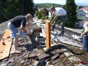 Renovations began immediately with plenty of volunteer help from sang members. Here we are removing the chimney portion of the fireplace