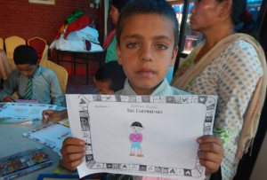Young boy holds his drawing of the day of the earthquake