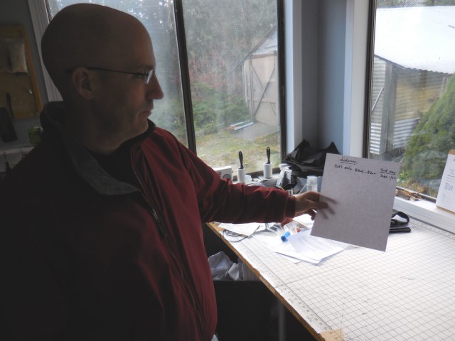 Koshin Christopher Cain reading a handwritten notice for a Still Sitting order.