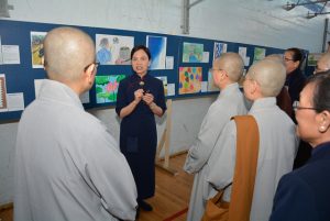 Monastics view children’s art at the event