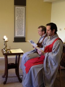 Tim Lerch wears a red kasa over his robe, and Michael Schutzler wears brown, as they lead a precepts ceremony in 2011.