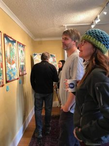 November visitors at the grand opening of Salga's studio, admiring the paintings.