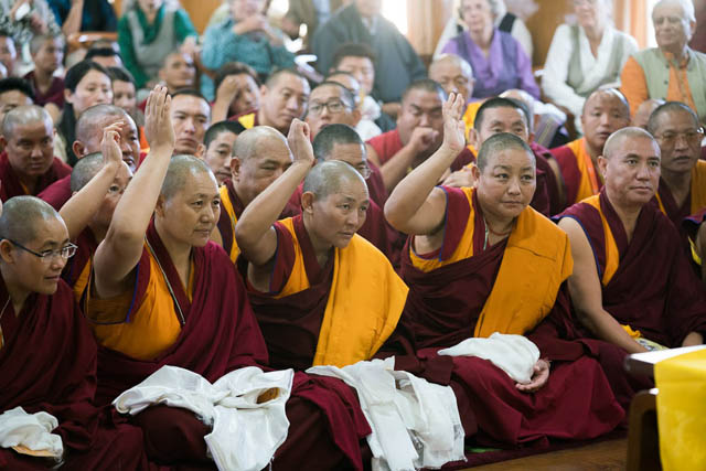 The first geshema nuns, the first to win the equivalent of doctorate degrees, identify themselves during an audience with the Dalai Lama.