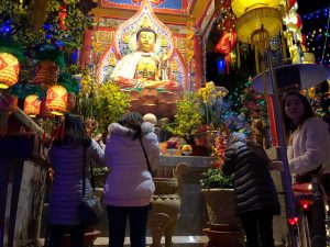Women with incense bowing to the Buddha, at Dia Tang Temple's Lunar New Year Celebration