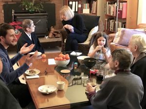 Members gather in the living room for a holiday breakfast