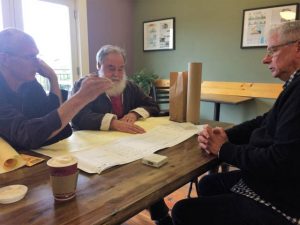 Three of the founders of the Port Townsend Meditation Center look at some preliminary layout plans. From Left to right: Isaac Gardiner, Bill Porter, and Walter Parsons