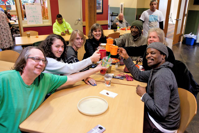 Recovery Café members take a break from their game to cheer recovery!