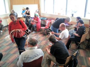 Members engage in basket weaving, a class offered through the School for Recovery.