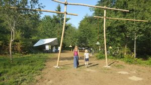 Elizabeth Fitterer and her son Grant walk through a gateway to the land, ingeniously designed and constructed by Marcus Berg on the eve of the dedication